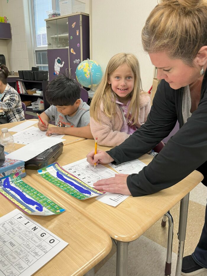 MyUSA staff working with a student at Mayfield Elementary for Adopt a Class