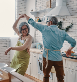 Old couple dancing in the kitchen