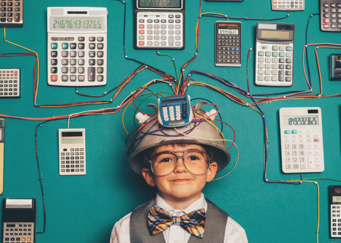 Young boy surrounded by calculators