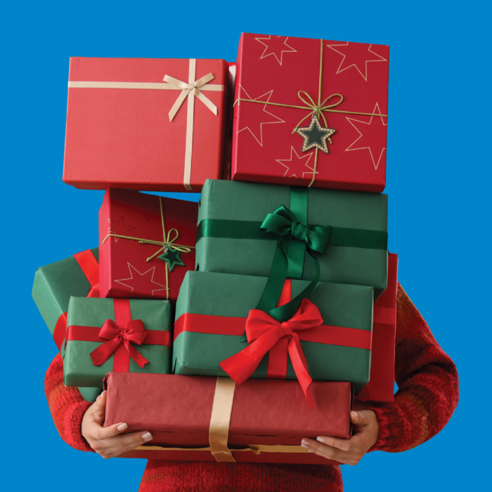 Person holding a tower of gifts